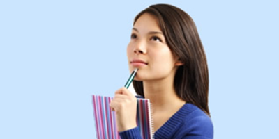 Credit transfer - girl with a notebook and pen. Light blue background.